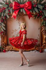 Festive red holiday dress with puffed skirt and embroidered silver bows

