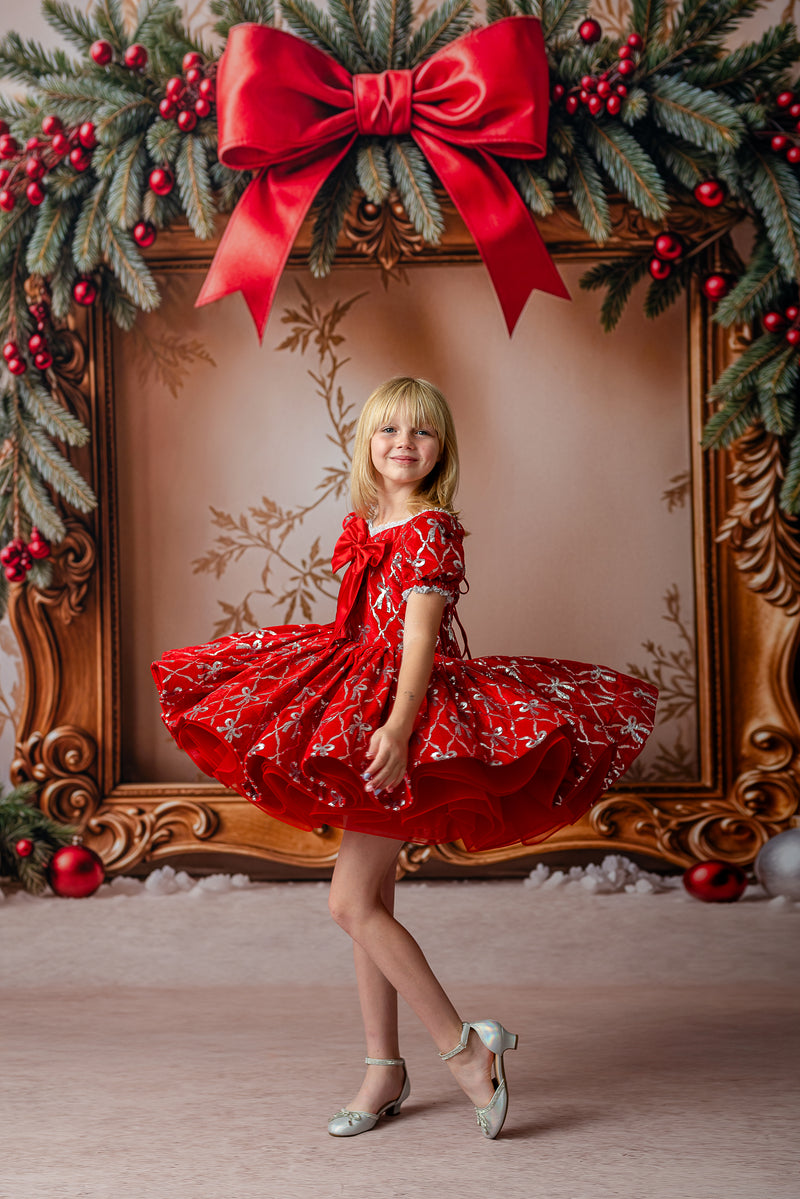 Festive red holiday dress with puffed skirt and embroidered silver bows

