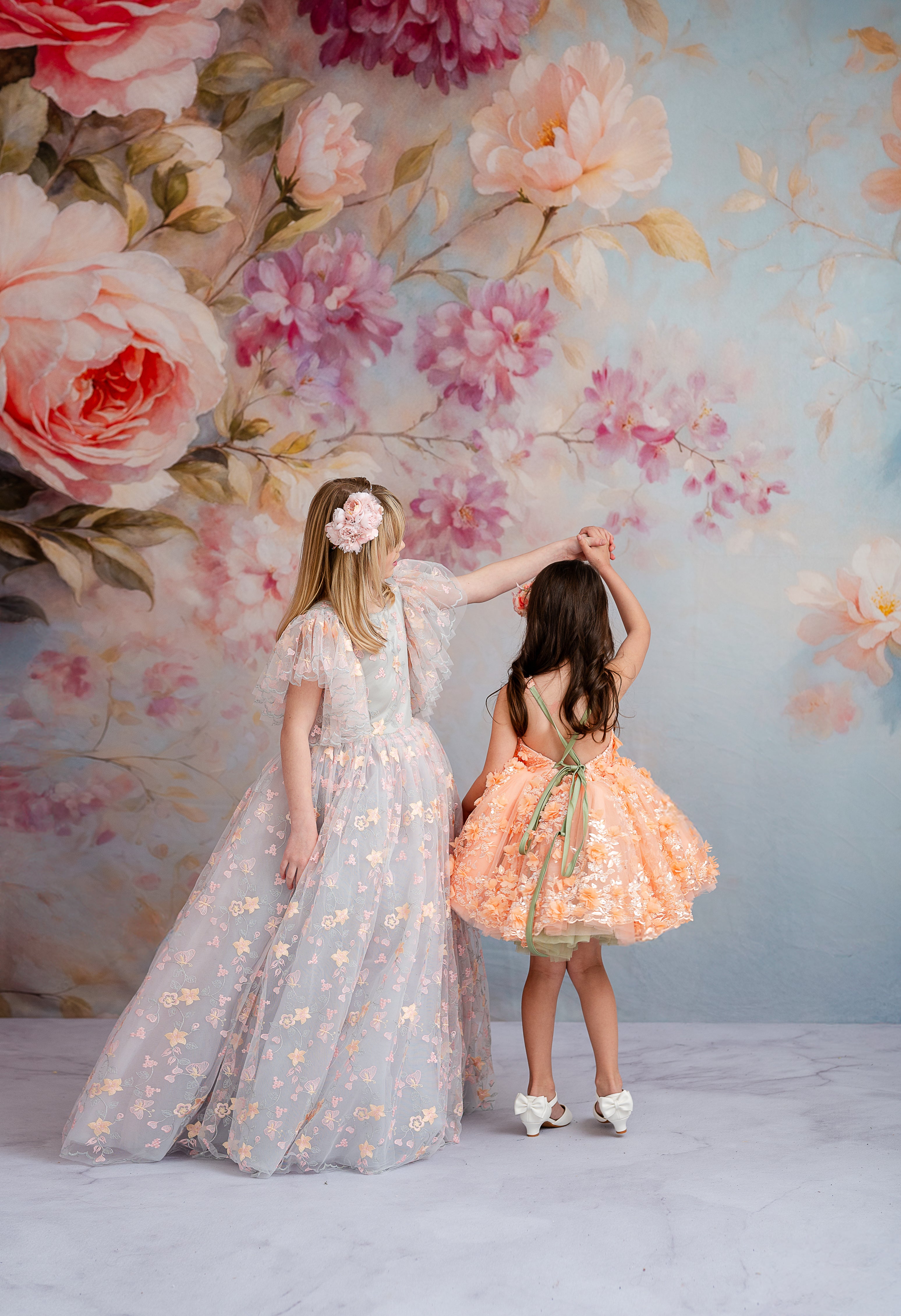 "Focused shot of the 'Peach Blossom' vintage design, featuring its soft peach palette, beautifully embroidered florals, and a flowy, petal-length skirt."






