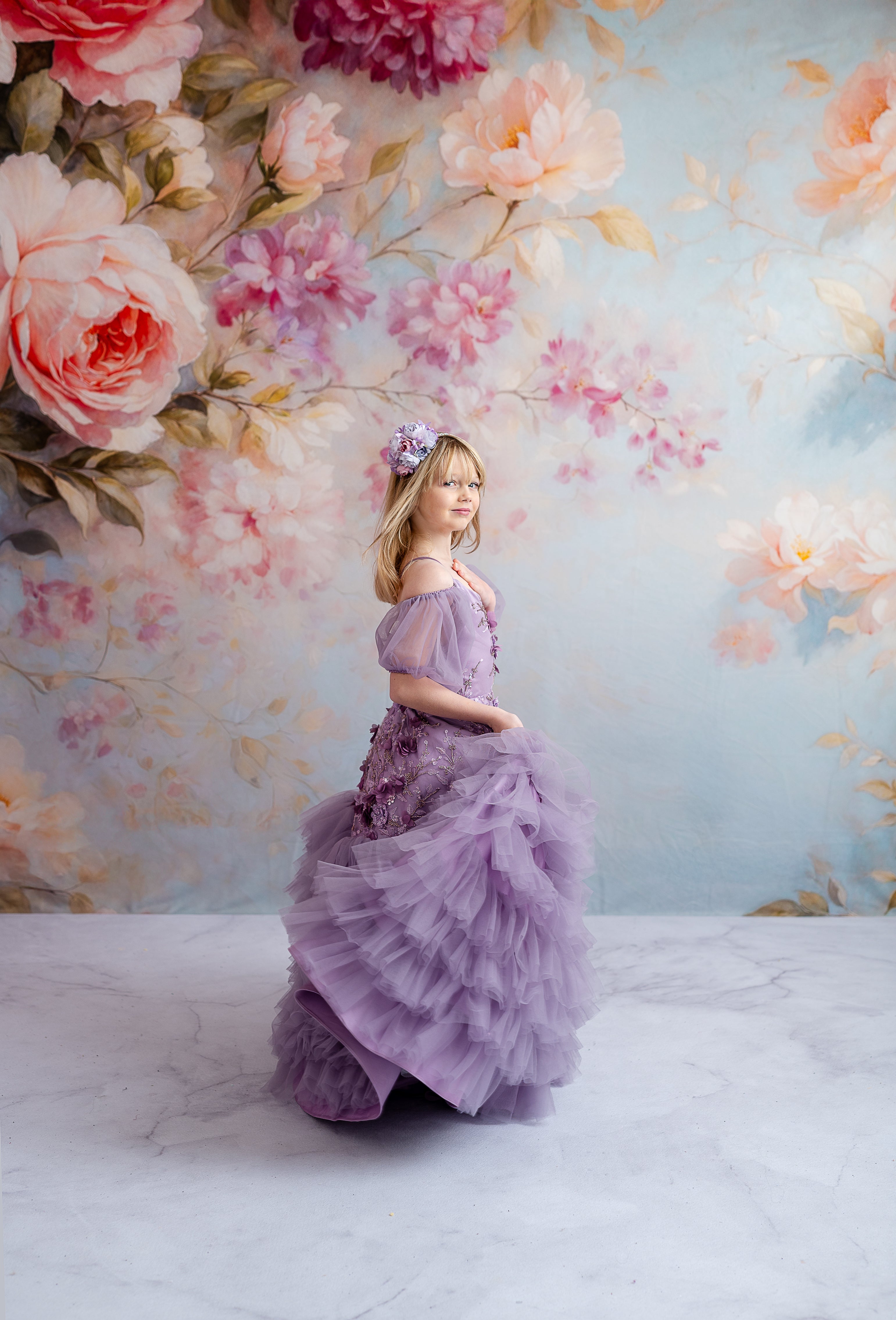 Delicate lavender gown with cascading floral appliqués and optional puff sleeves, creating a timeless, versatile look.