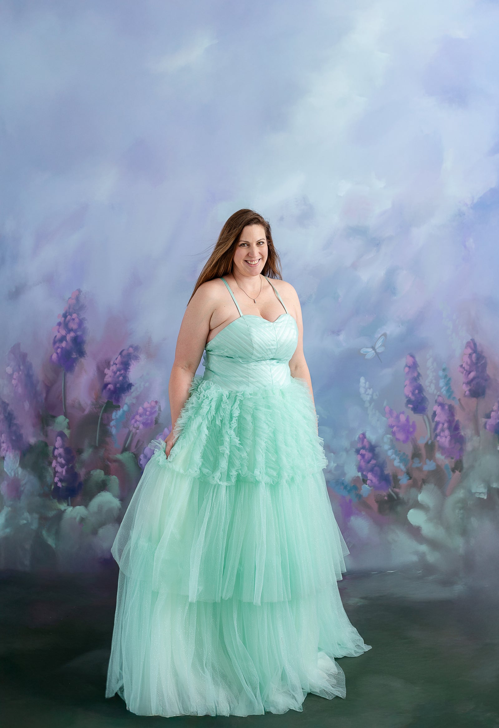 A little girl twirls in her voluminous gown while holding hands with her mother in a matching dress.
