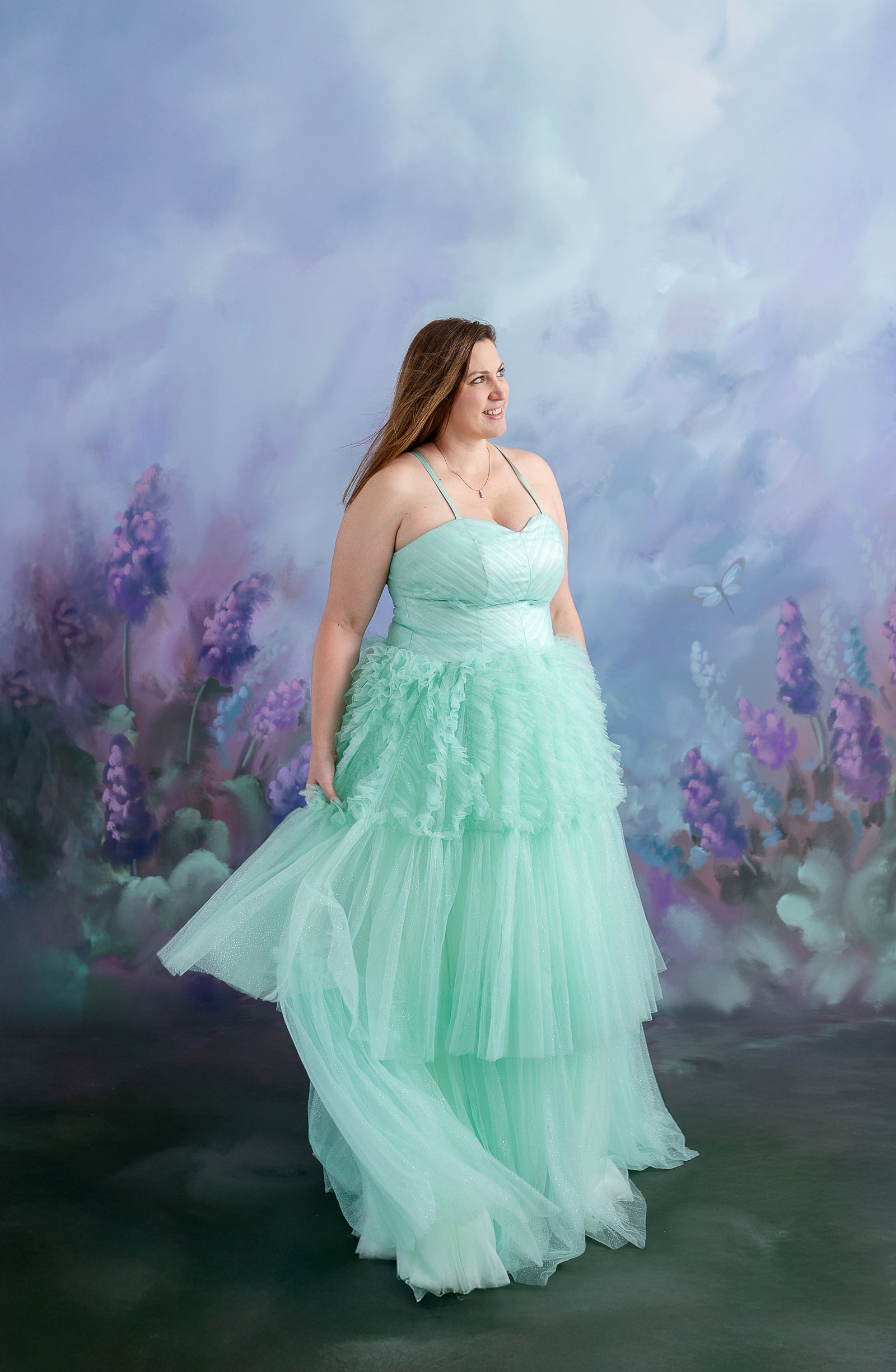 A mother-daughter duo stands together in elegant tulle gowns, creating a whimsical and dreamy portrait.
