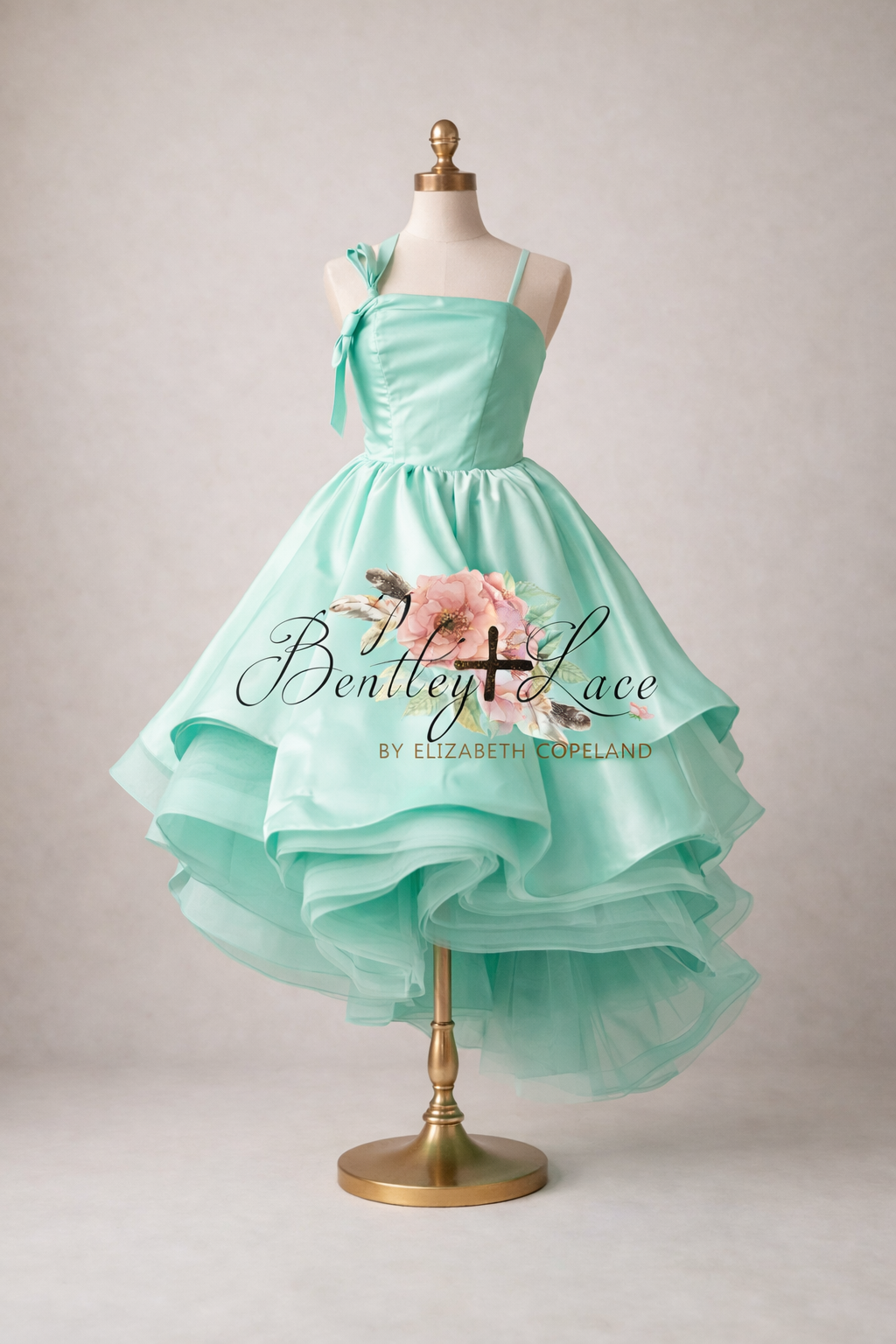 Mint green dress on a mannequin with 'Bentley & Lace' branding.
