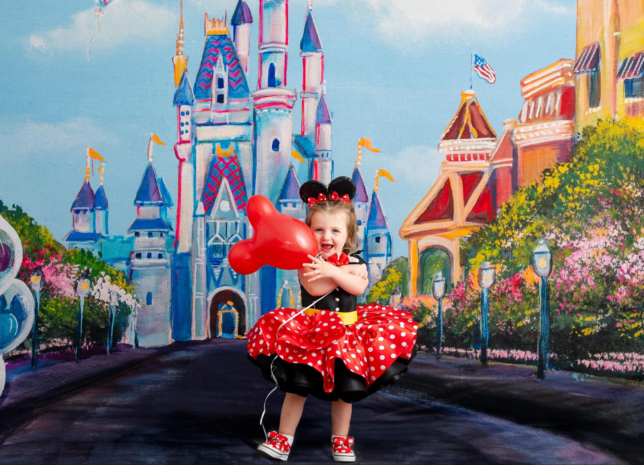 Minnie Mouse-inspired gown with puff sleeves, black bodice, and red polka dot skirt.
