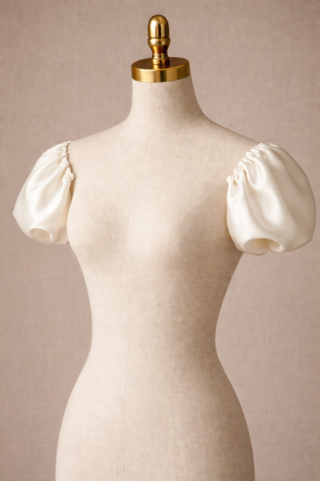 Mannequin wearing a cream-colored dress with puff sleeves against a beige background