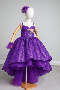 Purple sequin dress on a mannequin with a gray background