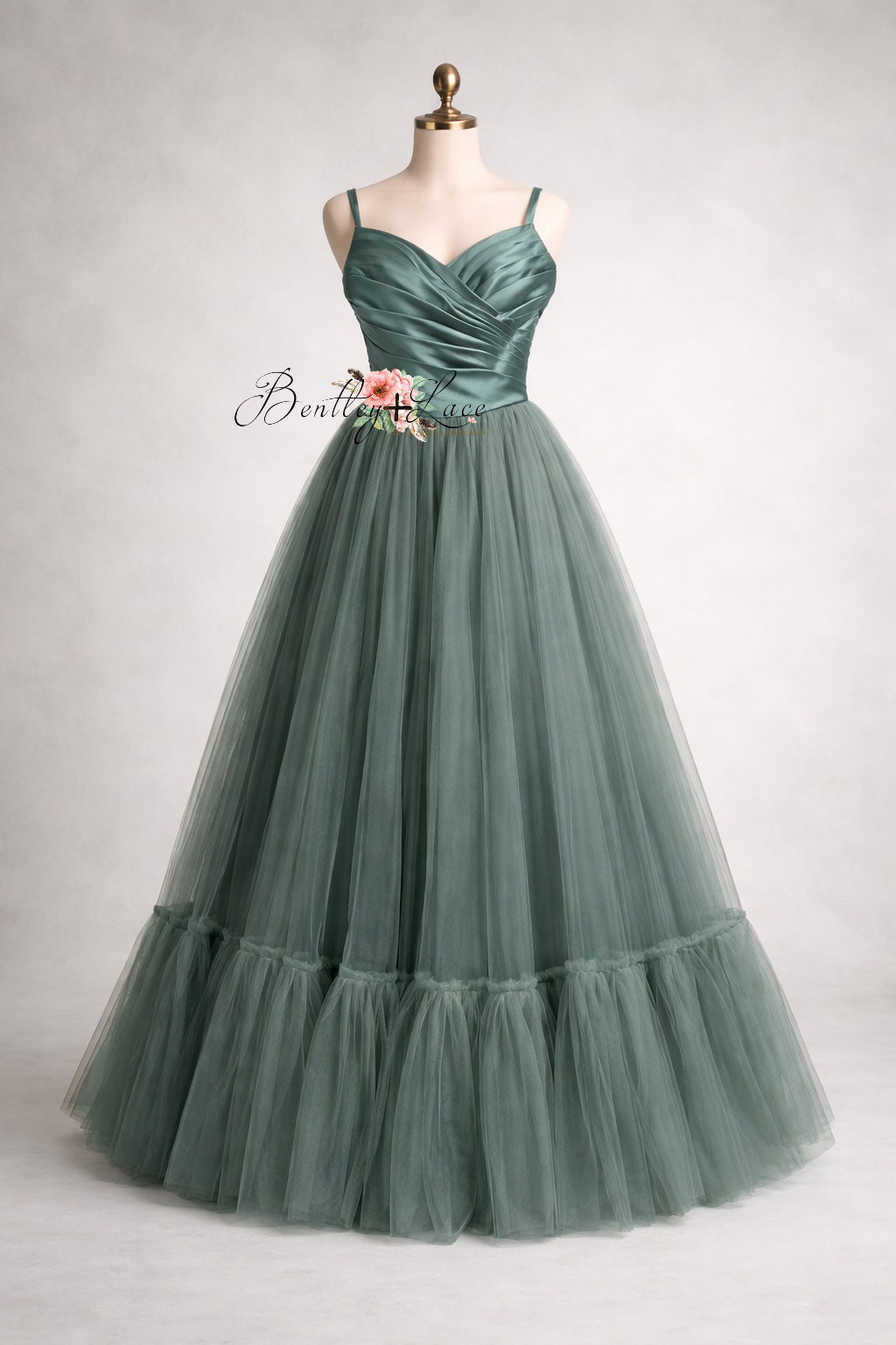 Green evening gown on a mannequin against a white background