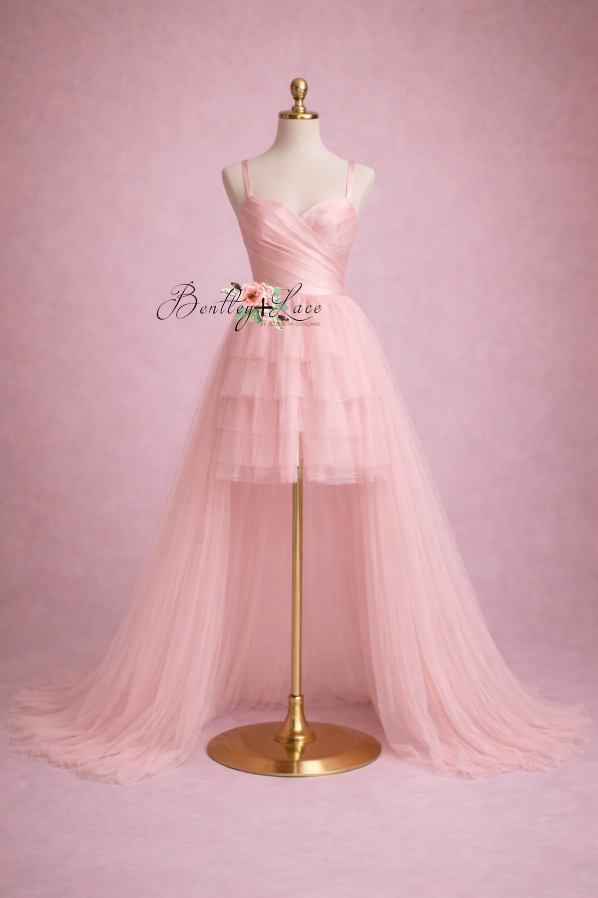 Pink dress on a mannequin against a pink background