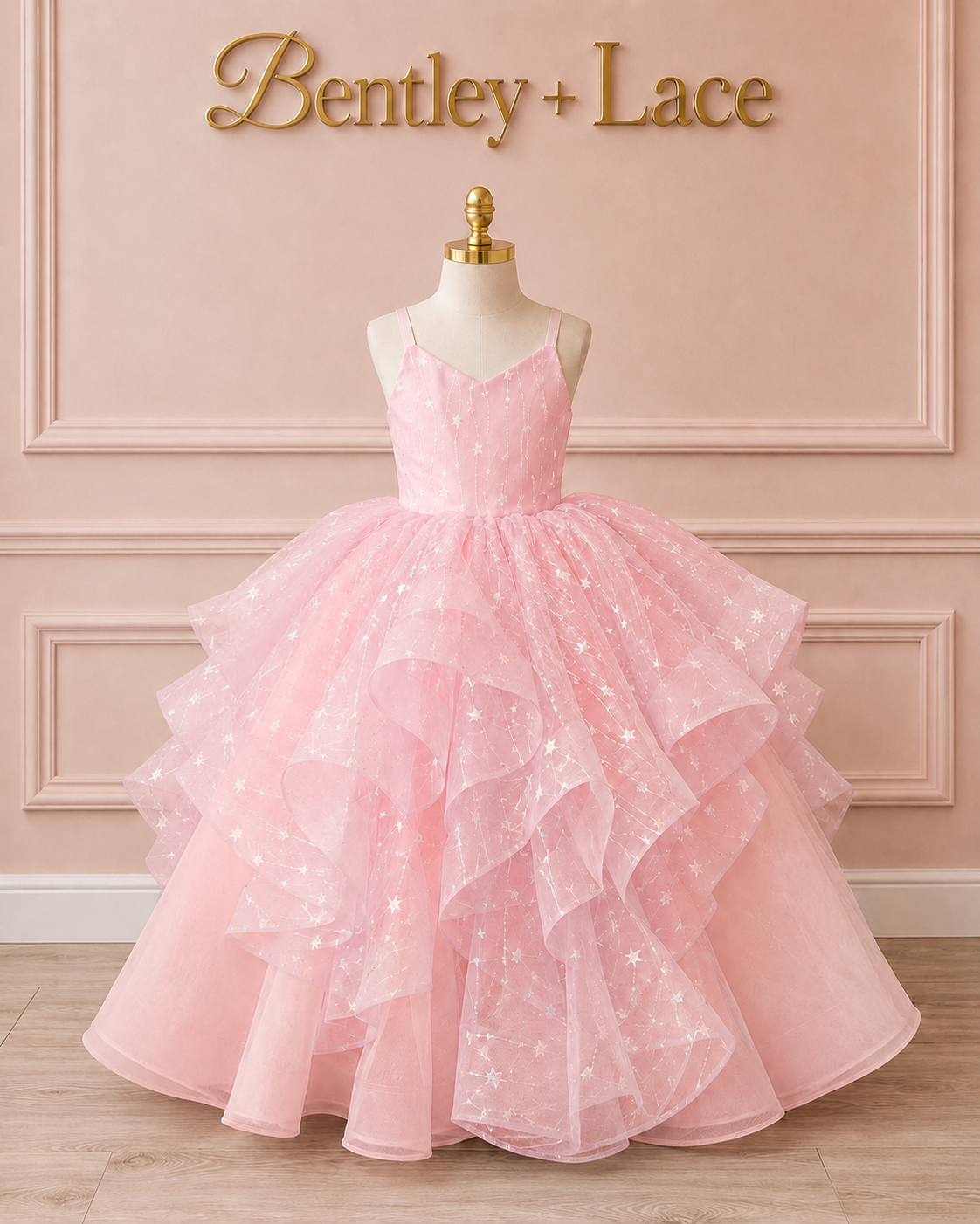 Pink ball gown on a mannequin against a pink wall with 'Bentley + Lace' branding.