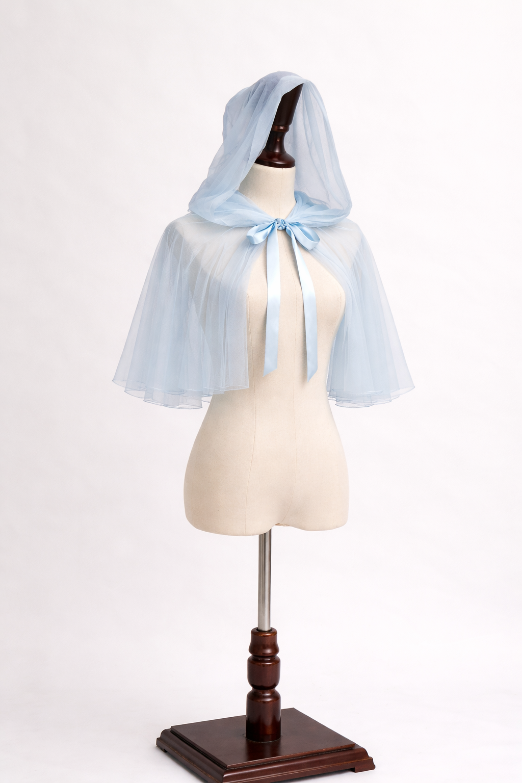 Light blue hooded cape on a mannequin against a white background