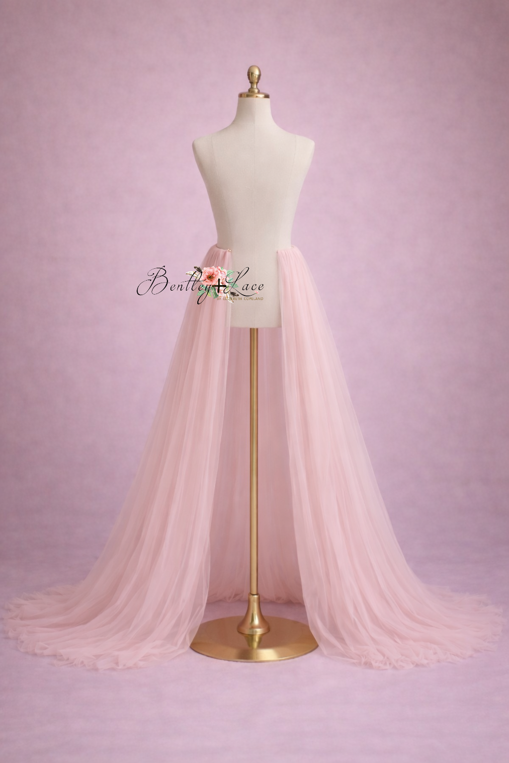 Mannequin wearing a light pink tulle skirt against a pink background