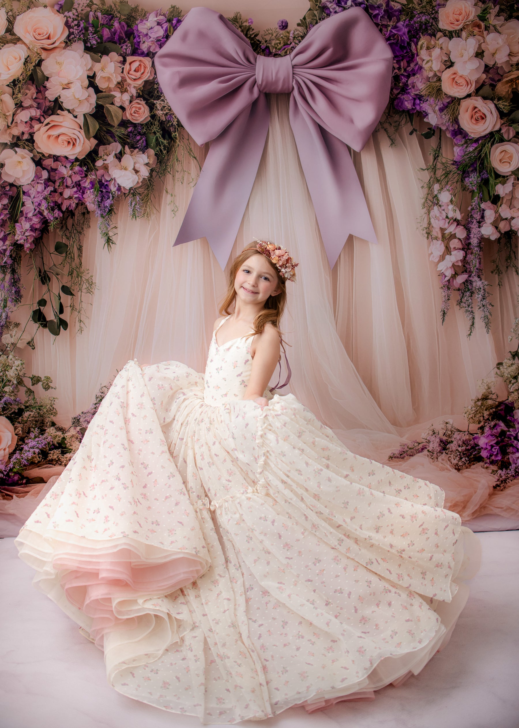 Young girl twirling in a luxury Bentley + Lace gown during her studio portrait experience.