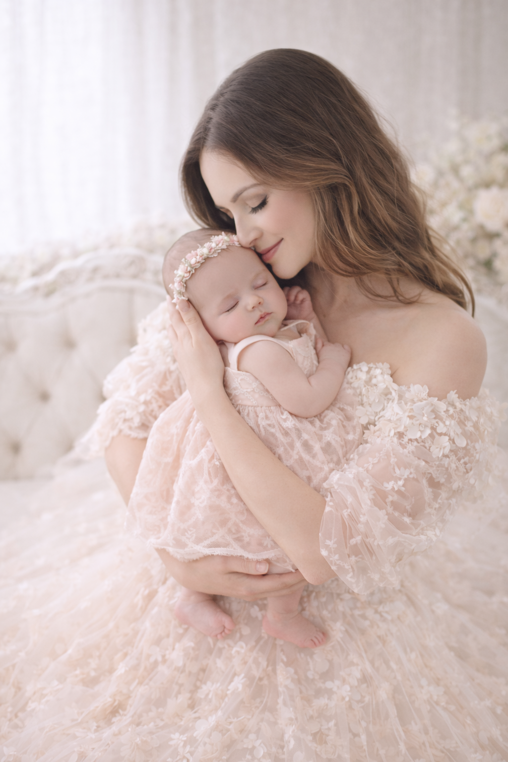 Woman holding a baby in a soft, blurred indoor setting