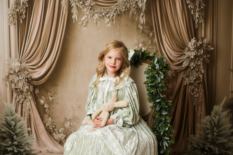 Styled portrait of young girl in Eleanor’s Dream sage green gown with coordinating bonnet for timeless heirloom photos.

