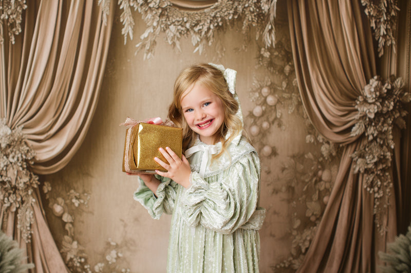 Close-up of Eleanor’s Dream vintage gown fabric texture and delicate detailing in sage green for styled children’s portraits.


