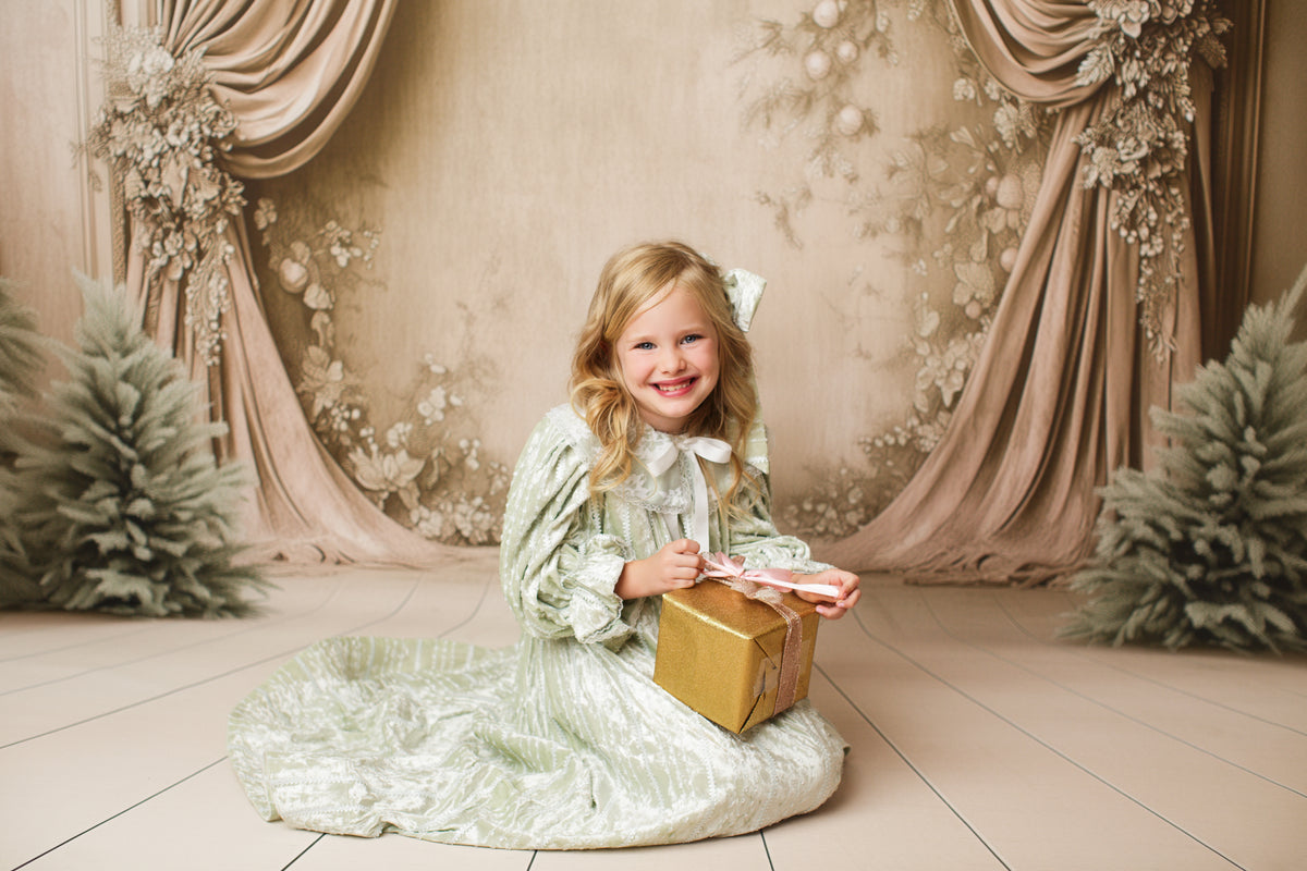 Styled photo of child in Eleanor’s Dream sage green vintage dress with classic collar and gathered sleeves for fairytale-themed sessions.

