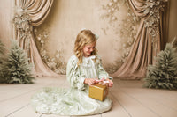 Little girl dressed in Eleanor’s Dream sage gown with romantic silhouette and faux button closure, perfect for heirloom portraits.

