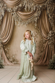 Toddler wearing Eleanor’s Dream sage green dress with old-world charm, perfect for vintage-themed photography sessions.


