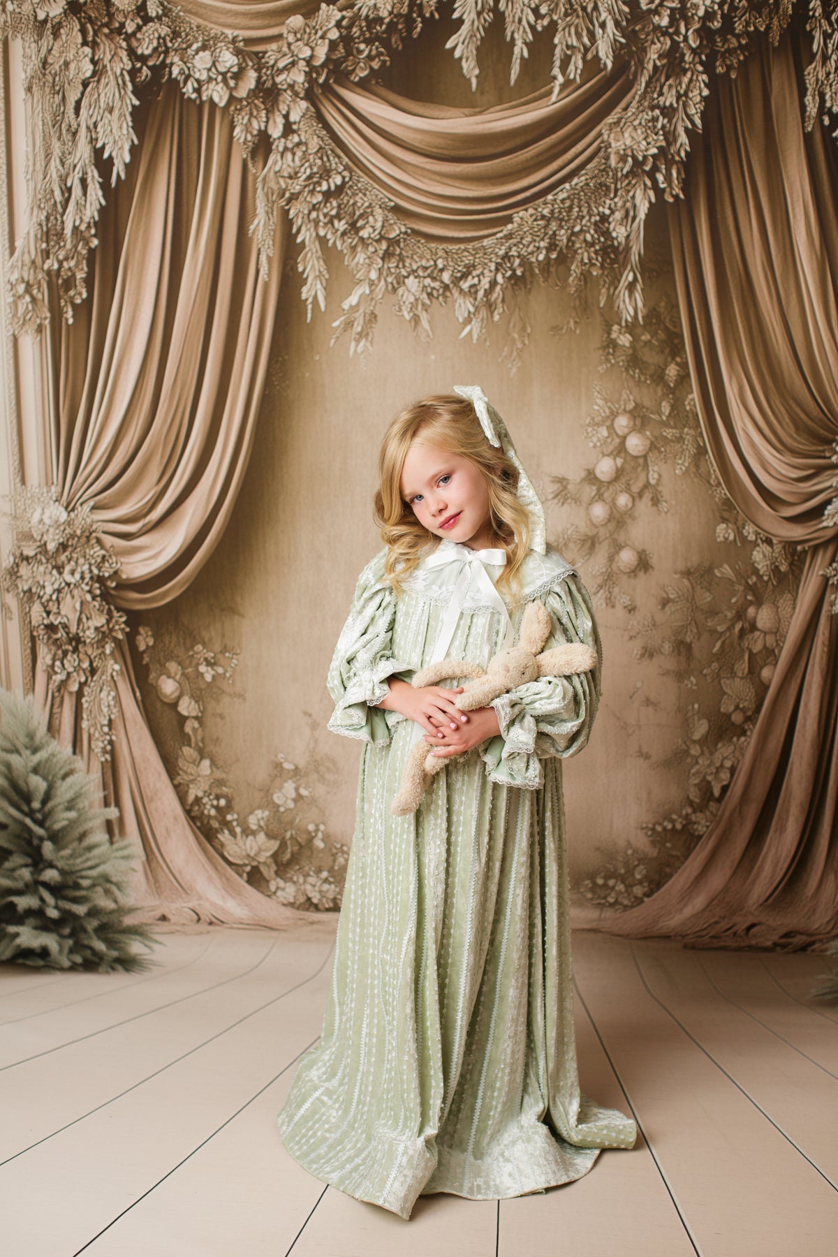 Child wearing Eleanor’s Dream vintage sage green dress with gathered sleeves and classic collar for styled photography sessions.

