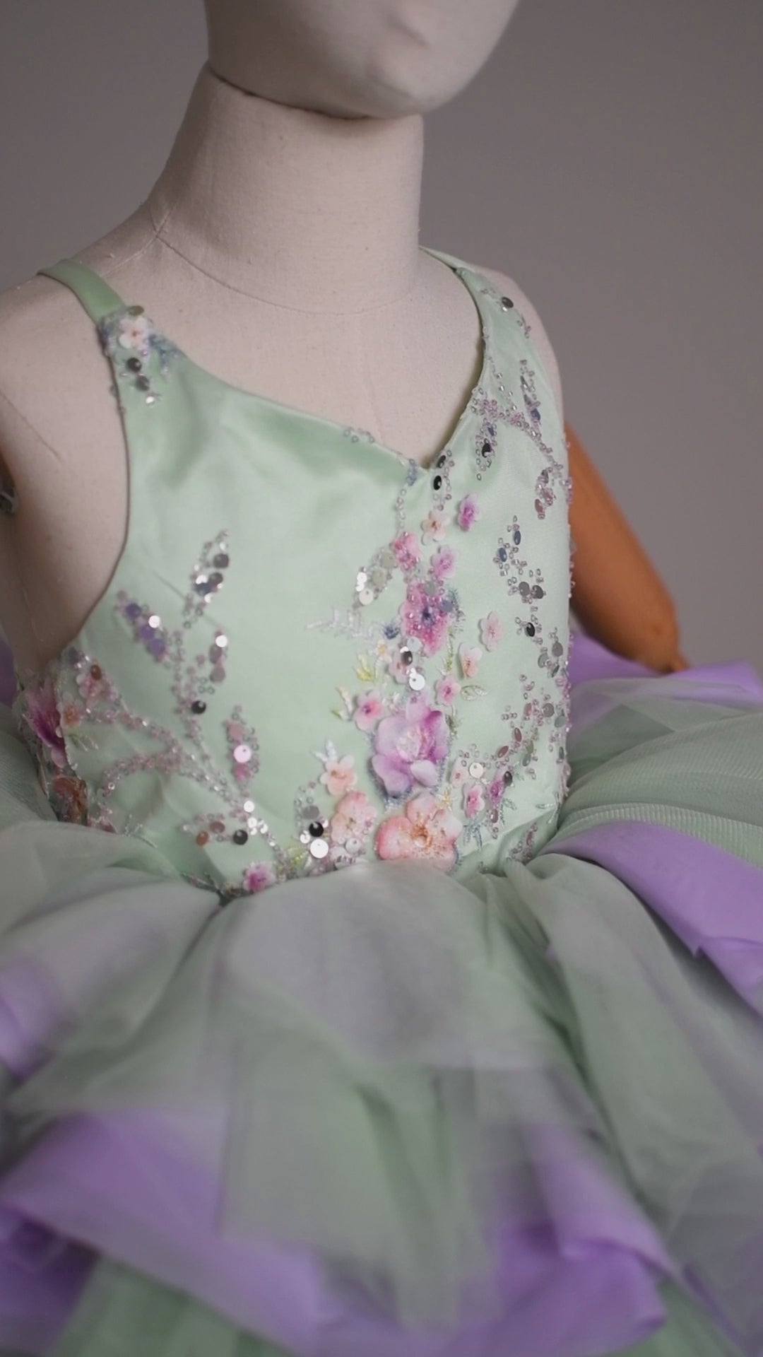 Short-style sage green dress with beaded sequin bodice and adjustable shoulder ties. Ideal for a charming and comfortable look. "Image of 'Meadow Mist' Petal Length Dress for Ages 4 to Petite 7 - Sage Green with Purple Accents"