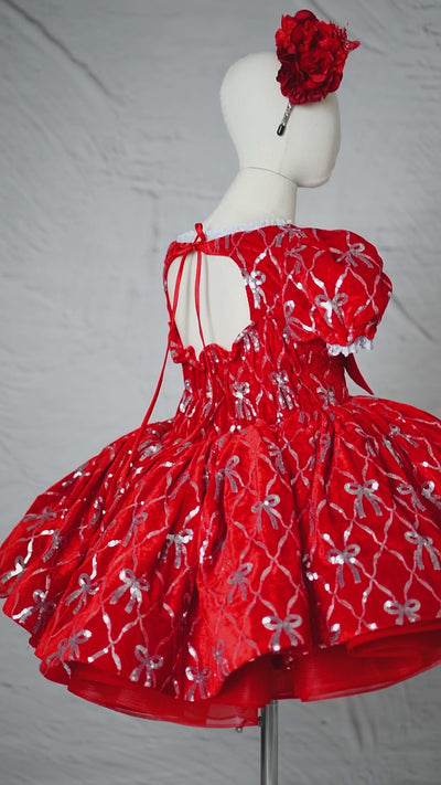 Back view of the dress featuring a voluminous skirt and fitted waist.

