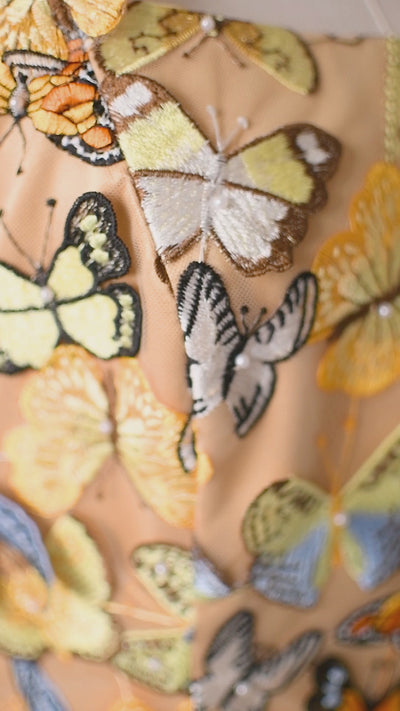 A stunning gown with a butterfly garden design, perfect for fairytale-inspired occasions.
