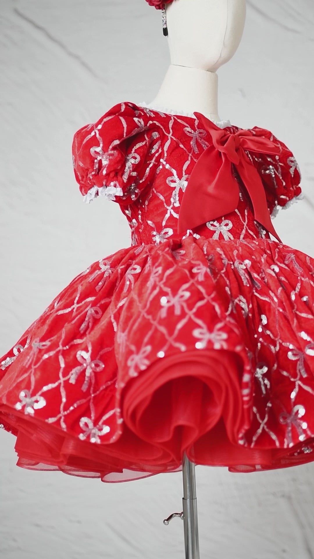 Holiday dress ensemble styled with matching red floral headband.

