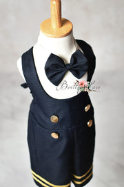 Navy blue children's outfit with bow tie on a mannequin against a plain background