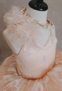 "A young girl spinning joyfully in the Anastasia gown, with the high-low skirt creating a dynamic, elegant motion."

