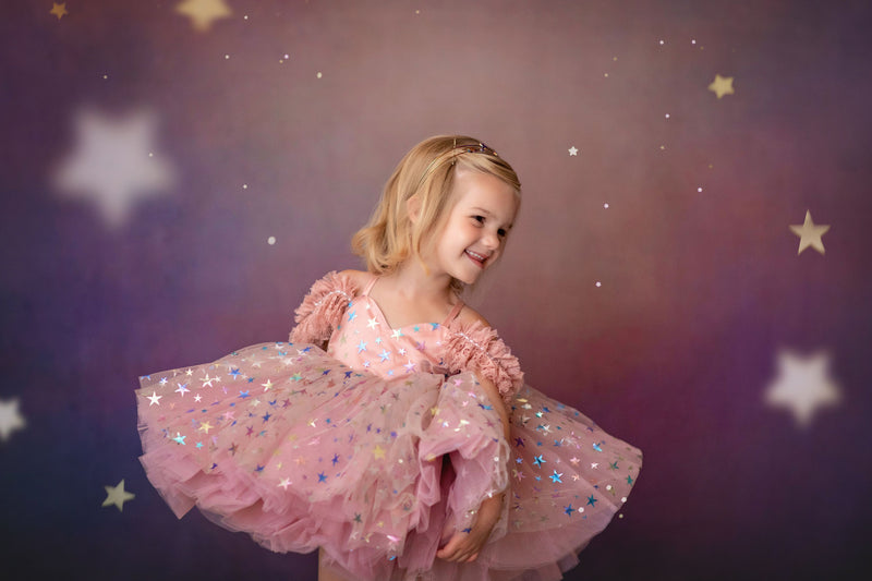 Whimsical flower girl dress with star confetti fabric and full skirt

