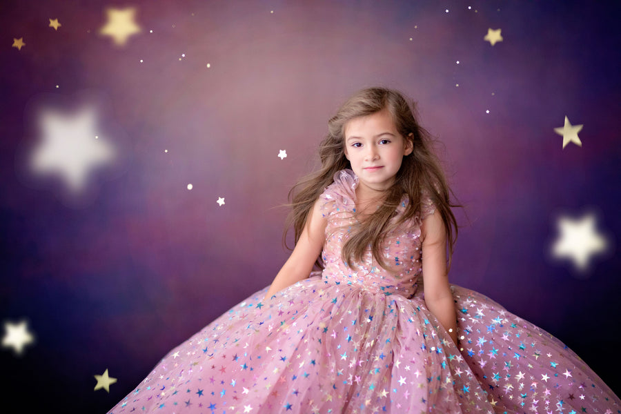 Starry princess gown on model with scenic outdoor backdrop

