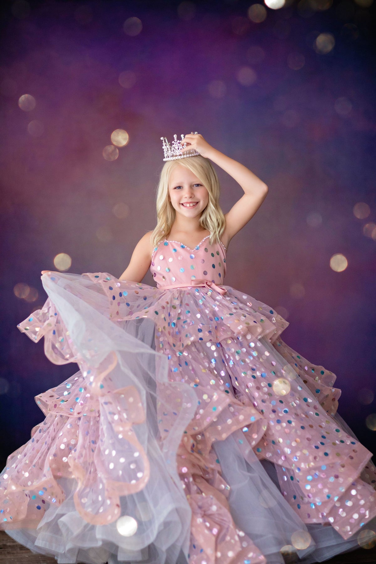 Girl in floor-length Confetti gown posing for flower girl photo shoot

