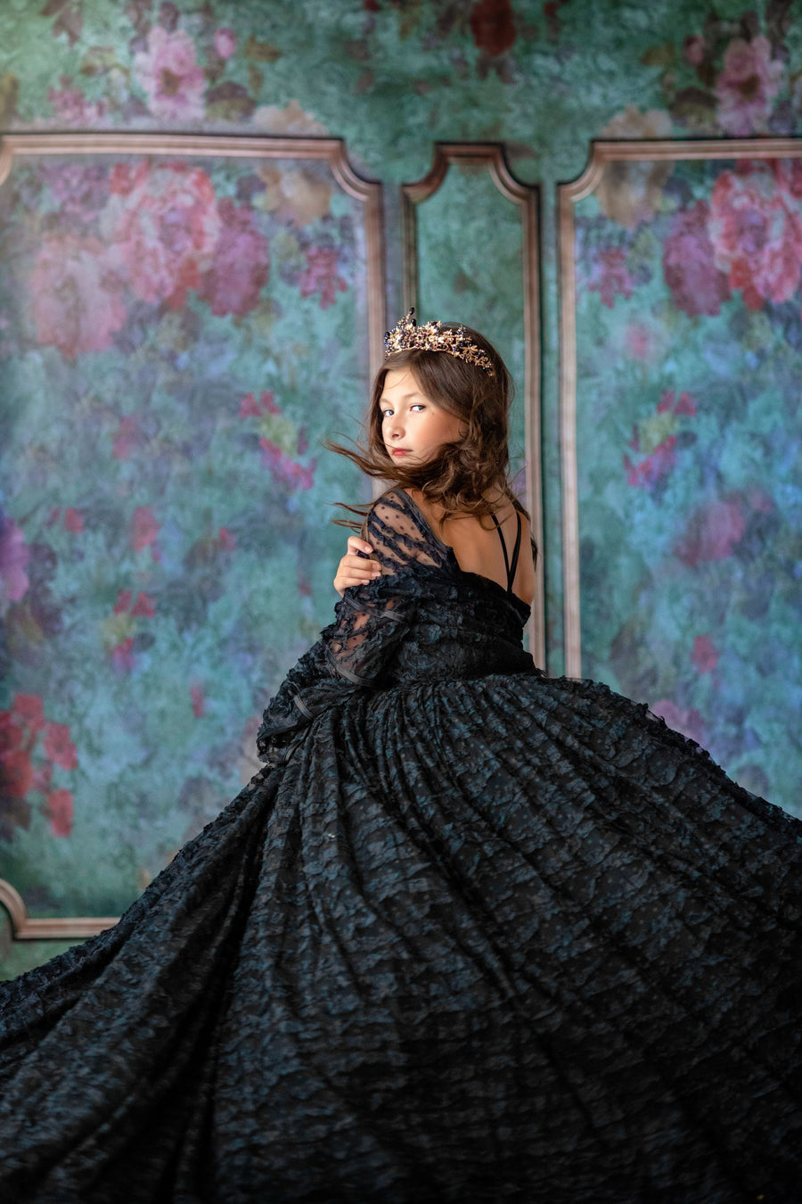 "Child twirling in a special occasion dress with full tulle skirt"

