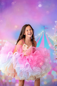 Little girl wearing the Petal Golden Starlight gown with embroidered star mesh

