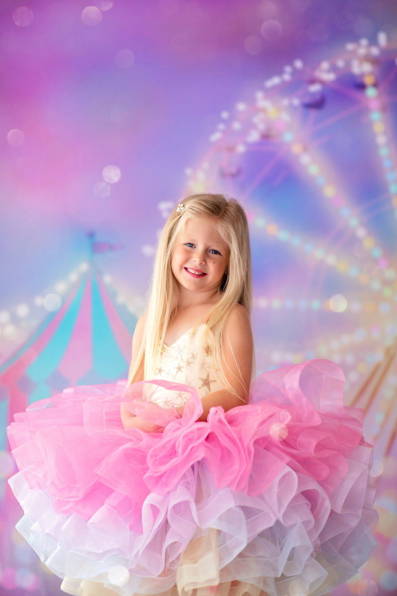 Flower girl twirling in the Golden Starlight dress with rainbow tulle skirt

