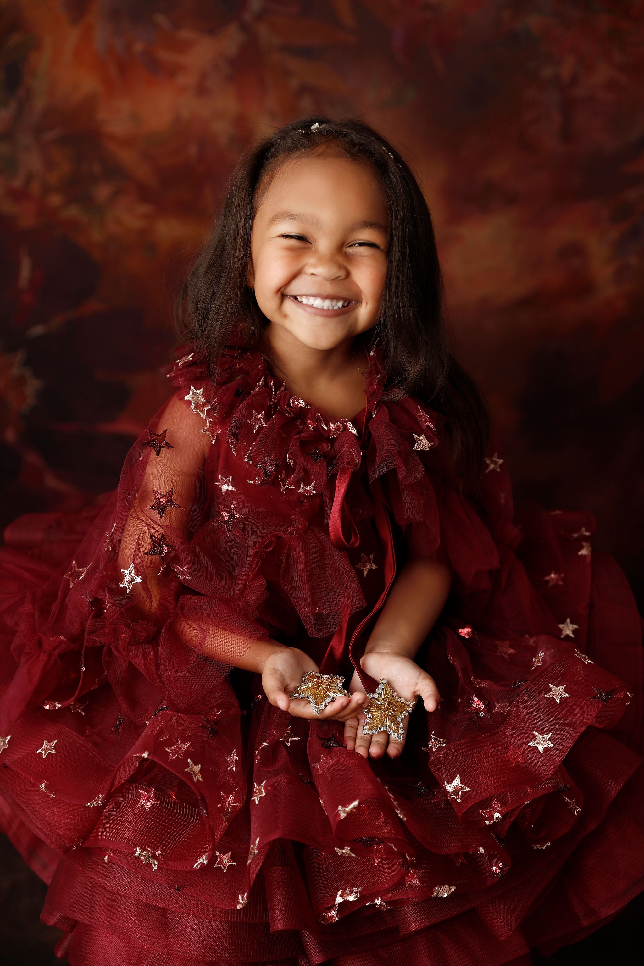 Starlet Burgundy Dress shown with cape draped gracefully over shoulders.

