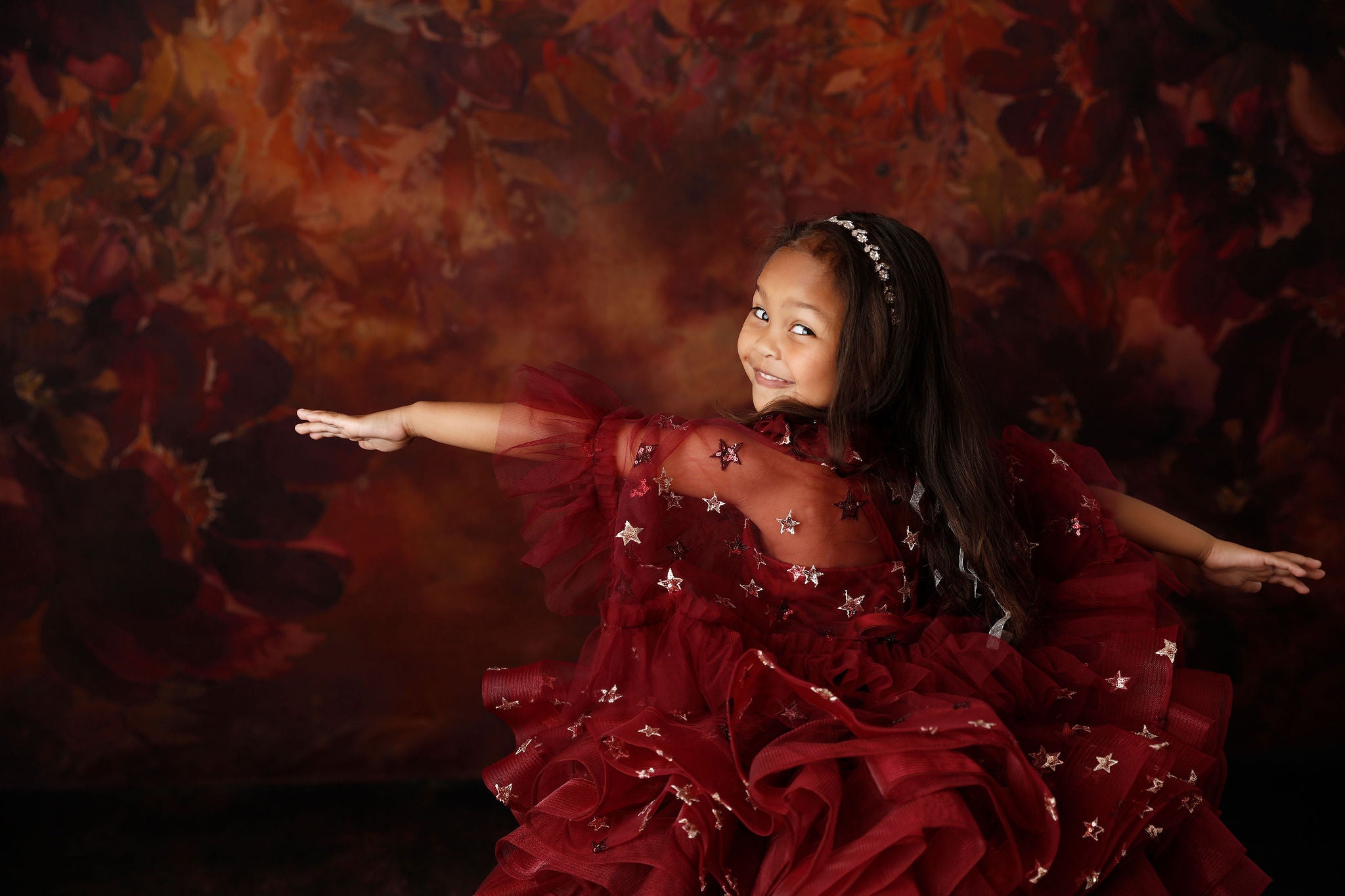Starlet Burgundy Dress shown with cape draped gracefully over shoulders.

