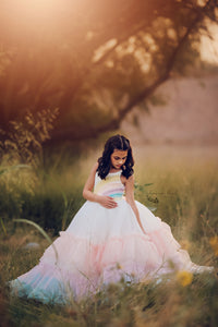 A multicolored striped dress with long sleeves and a tie waist, combining comfort with a bold rainbow aesthetic.

