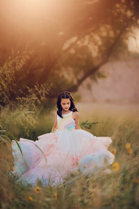 A rainbow dress with long sleeves and a tie waist, combining comfort with a bold rainbow aesthetic.

