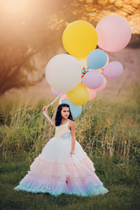 A tulle dress with layered rainbow colors, creating a whimsical and dreamy effect, ideal for special occasions.

