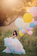 A sleeveless dress with a sweetheart neckline, showcasing a pastel rainbow ombre design for a subtle yet playful appearance.


