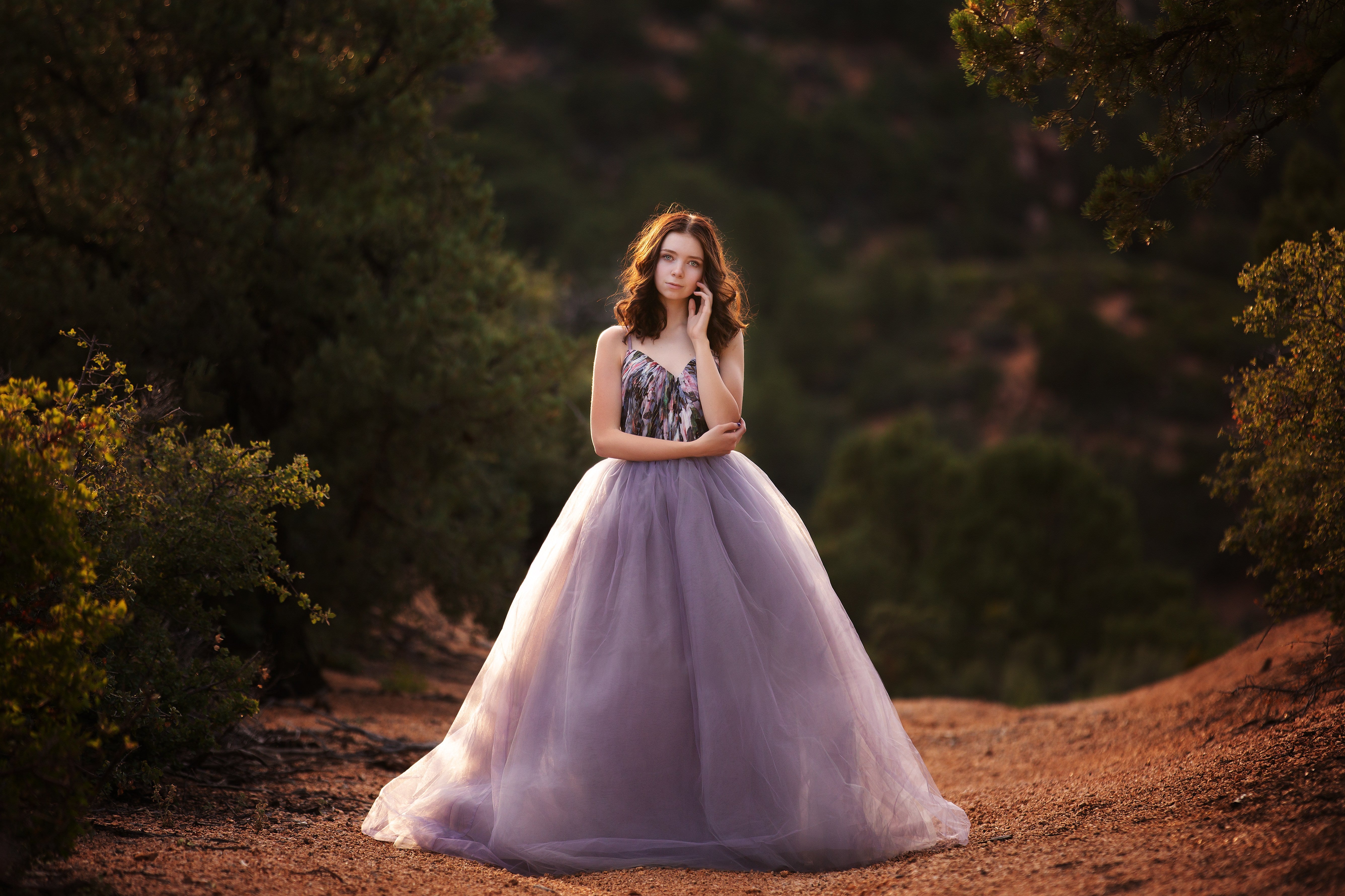 "Teen wearing a couture gown for a senior photoshoot, styled for a modern and elegant photography session."

