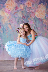 Detailed shot of the Heavenly gown’s bodice, emphasizing the floral fabric and gentle pastel blue tones.

