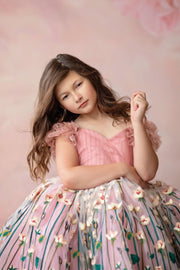 "Close-up of hand-embroidered floral fabric on a vintage-inspired children’s dress"

