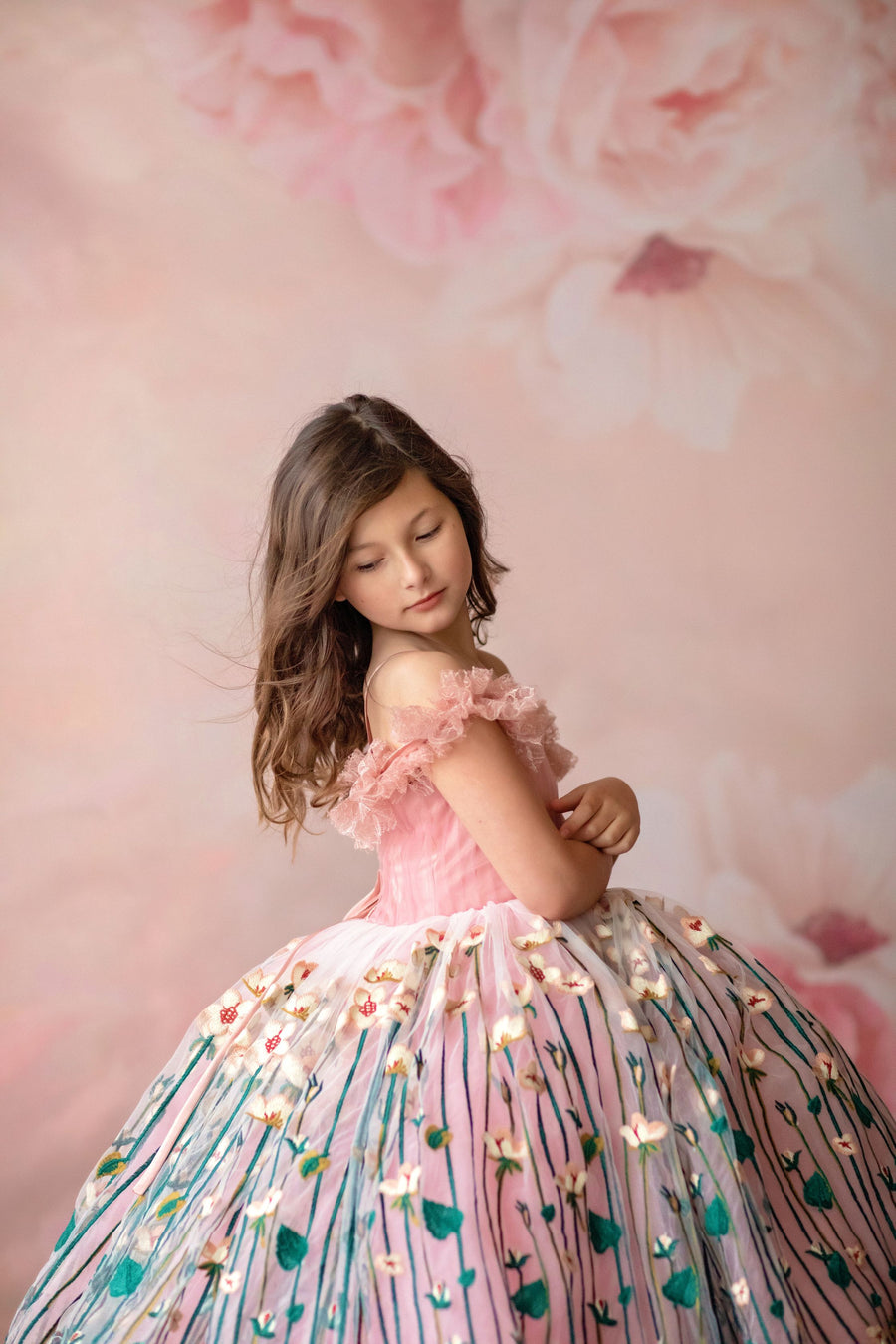 "Close-up of hand-embroidered floral fabric on a vintage-inspired children’s dress"

