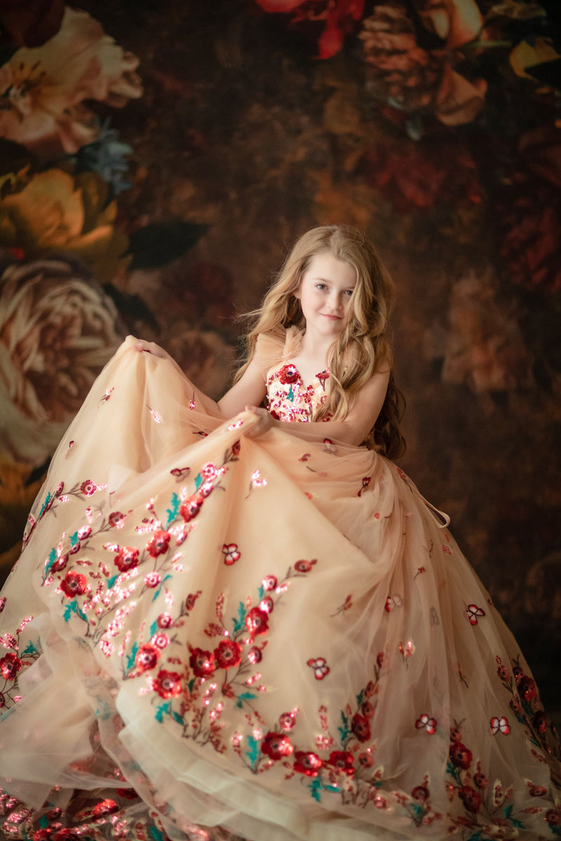 Young girl wearing a floral sequin gown for a flower girl photoshoot

