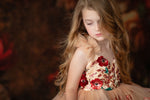 Young model posing in a princess-style dress with floral accents

