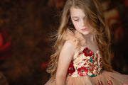Young model posing in a princess-style dress with floral accents

