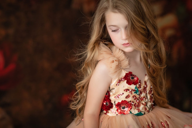 Young model posing in a princess-style dress with floral accents


