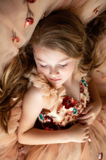 Children’s couture dress styled for spring or garden wedding

